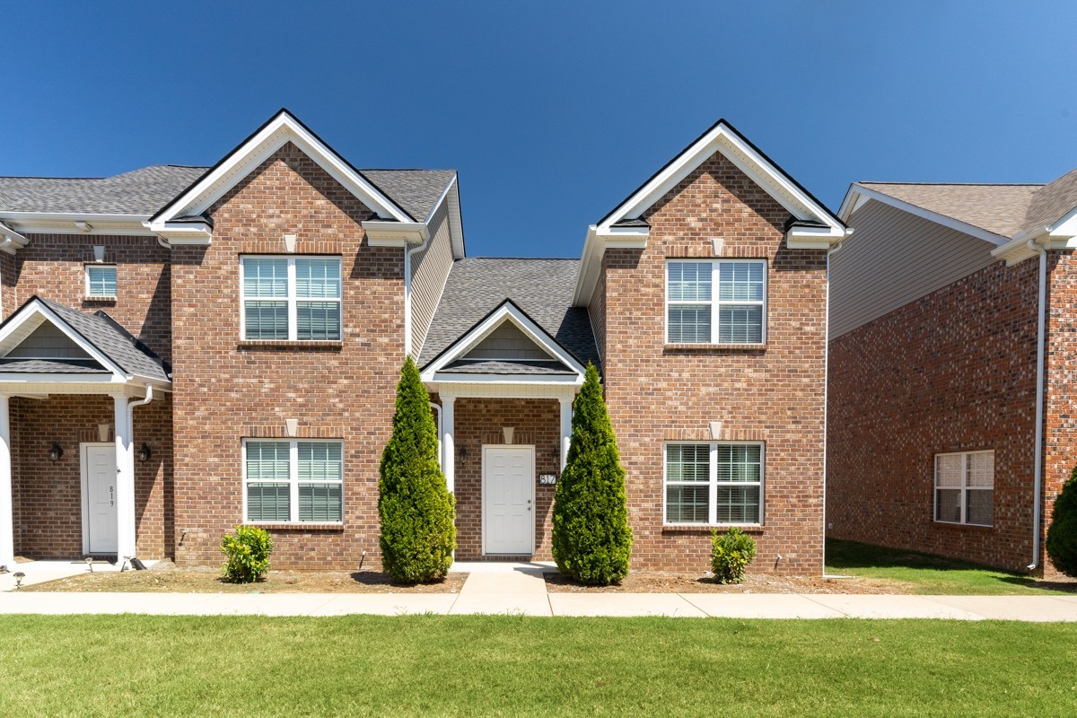 a front view of a house with a yard