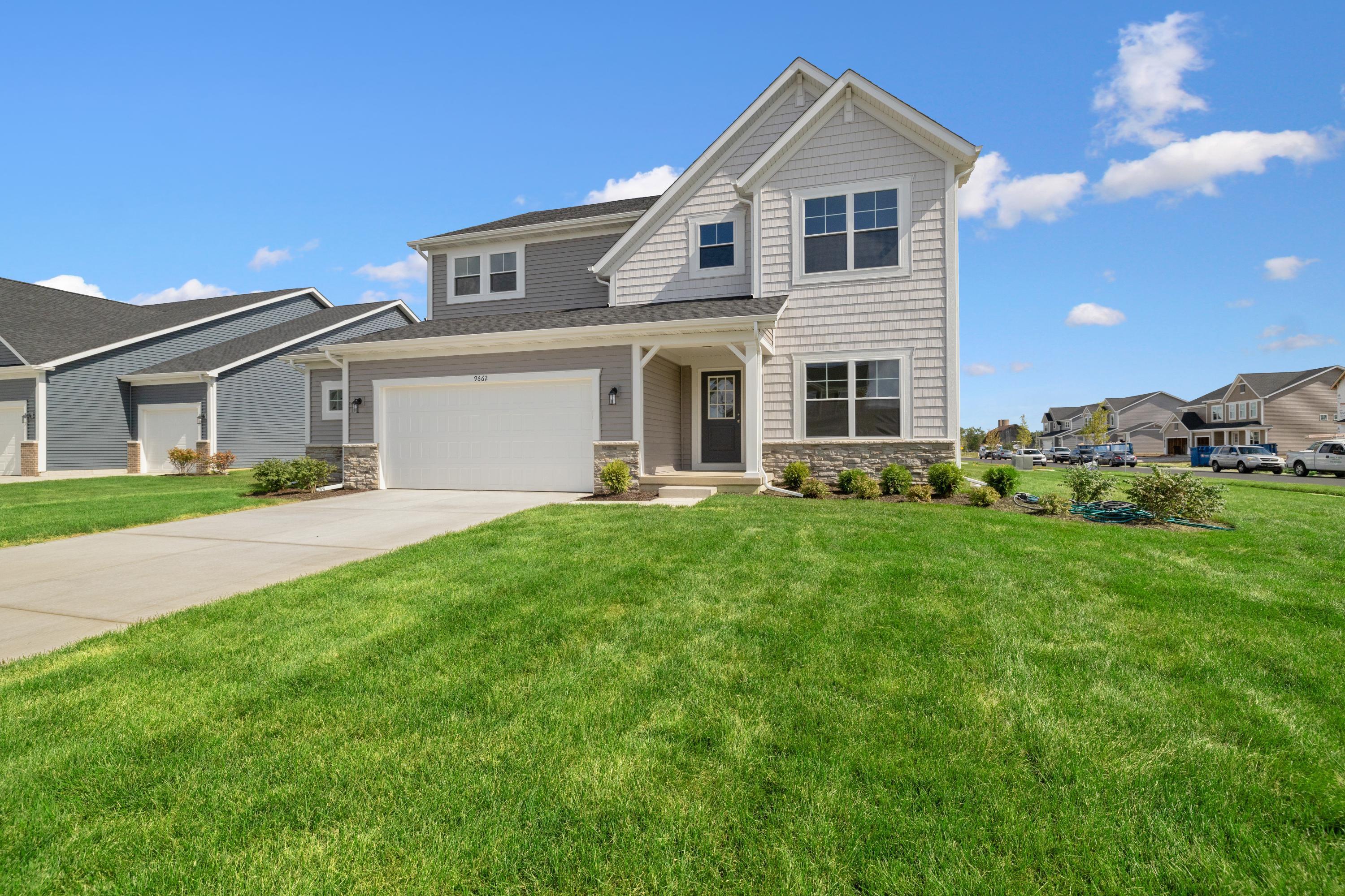 a front view of house with yard and green space