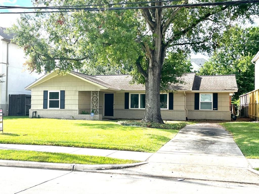 a front view of a house with swimming pool and yard