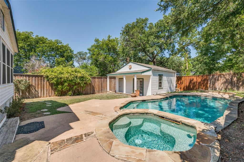 a view of backyard with swimming pool and outdoor seating