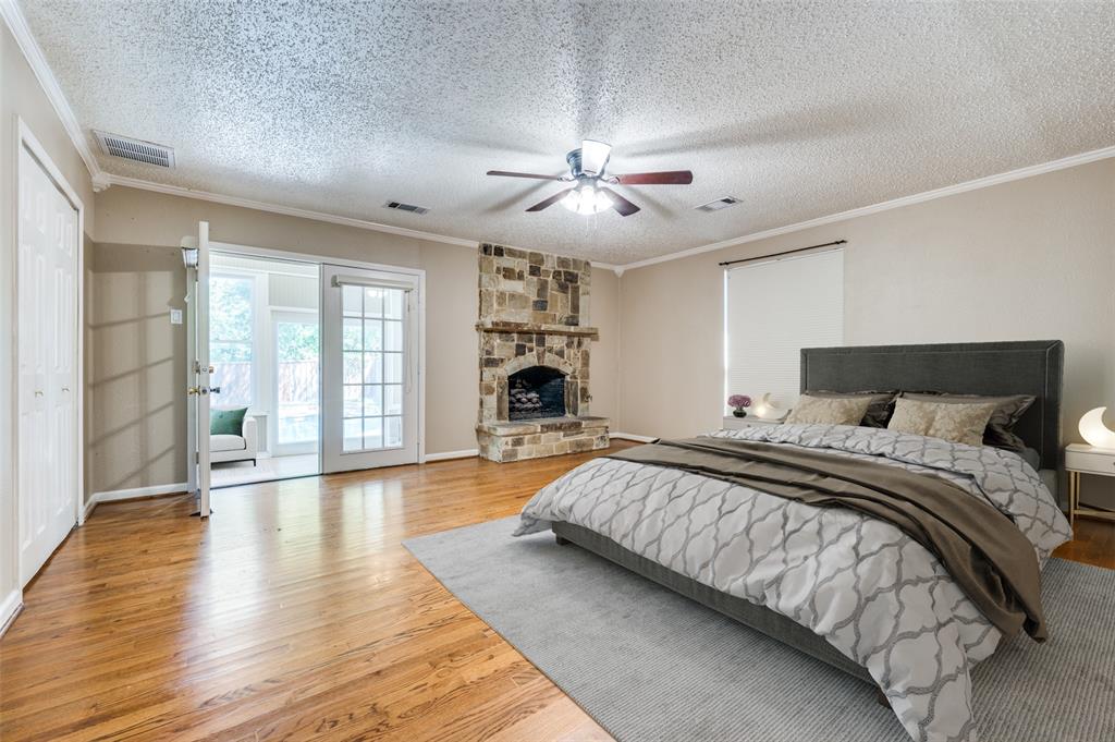 a spacious bedroom with a large bed and a chandelier