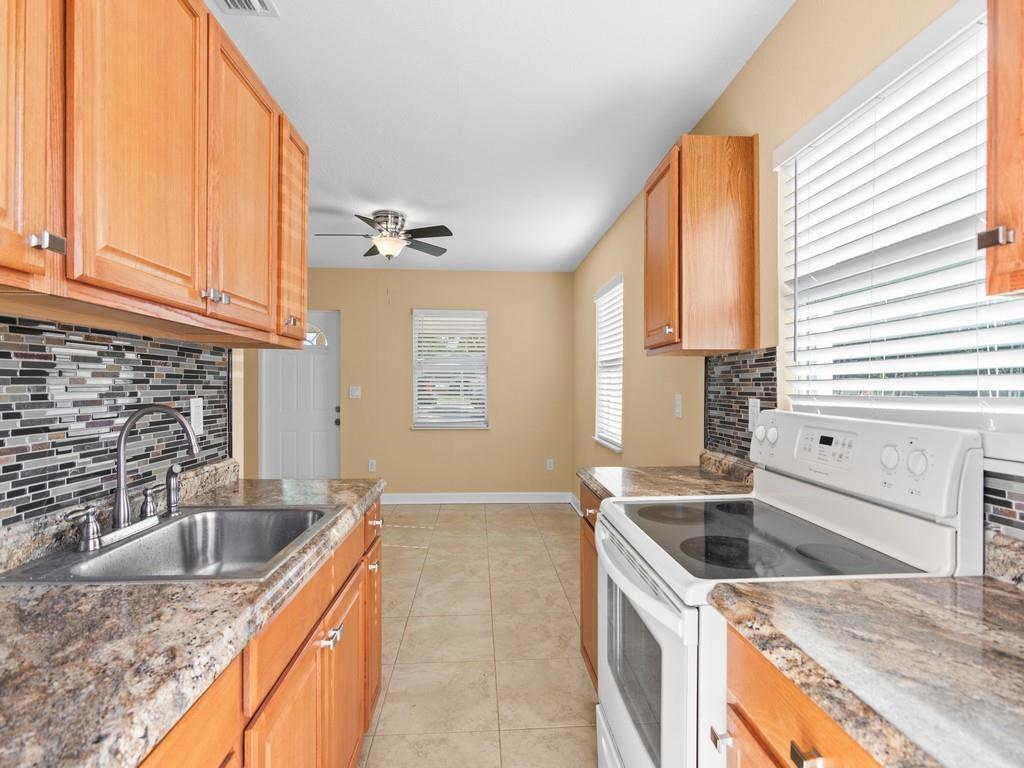 a kitchen that has a sink and a stove