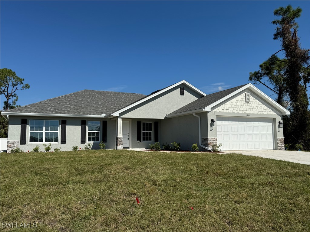 a front view of house with yard and trees