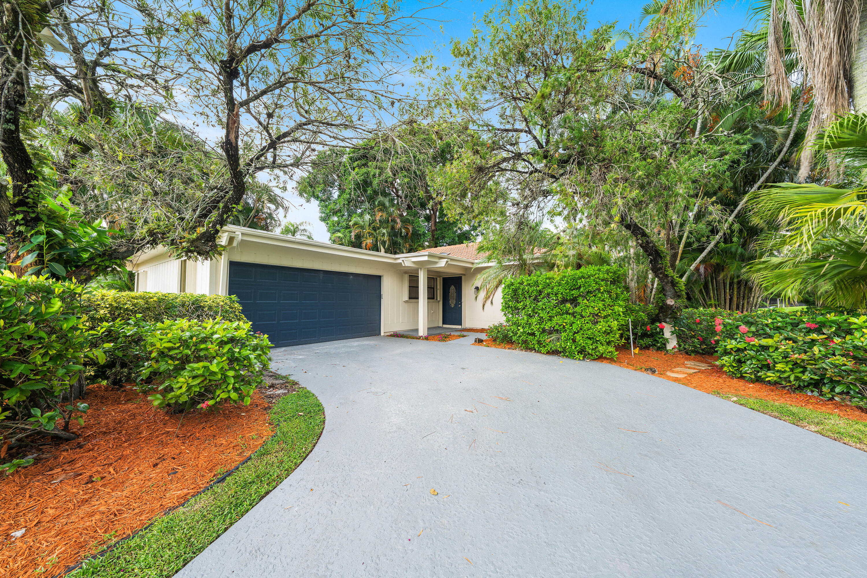 front view of a house with a yard and a garage