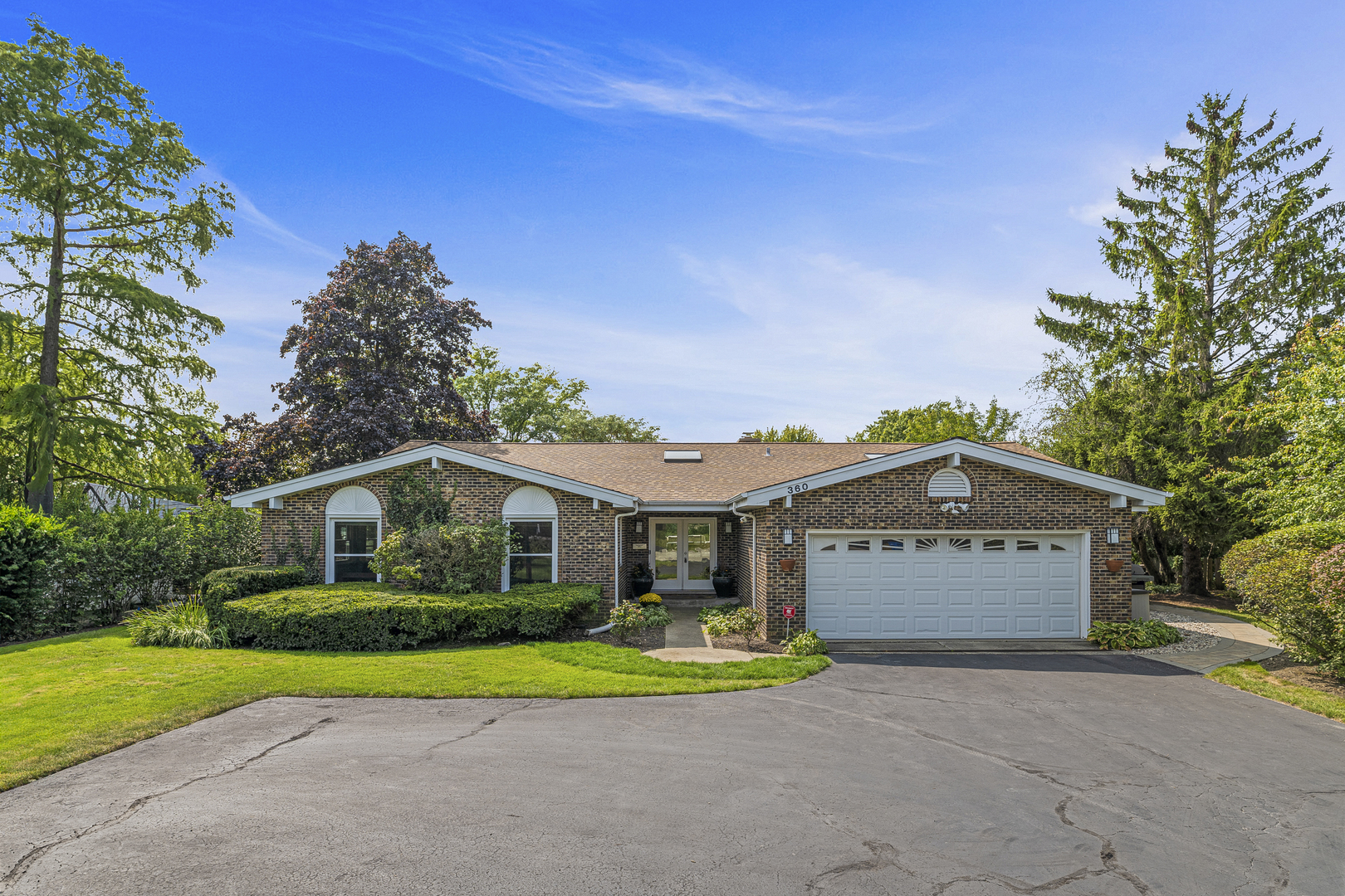 a view of a house with a yard and garage