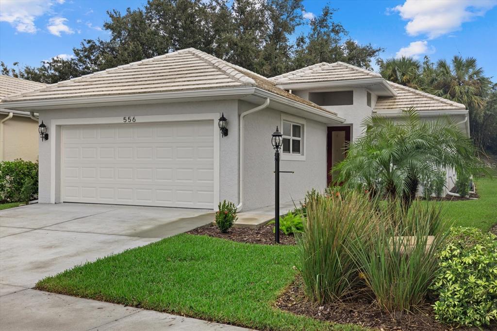 a front view of a house with a yard and garage