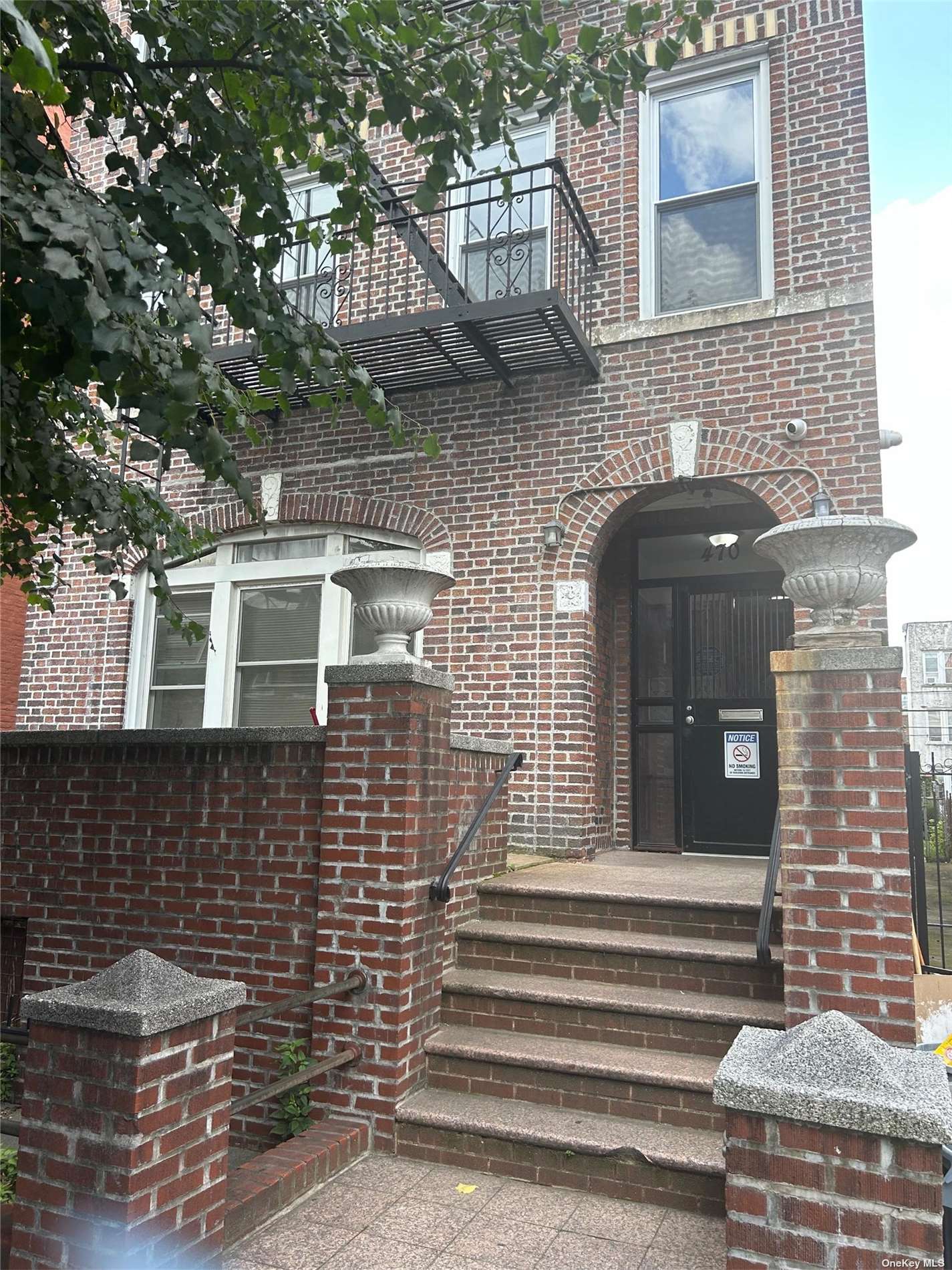 a front view of a house with stairs