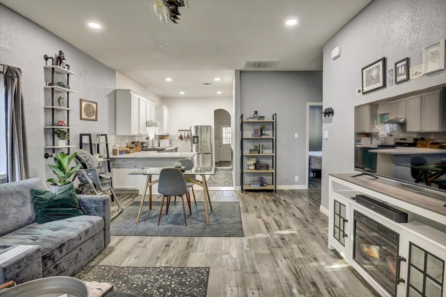 a living room with lots of furniture and kitchen view