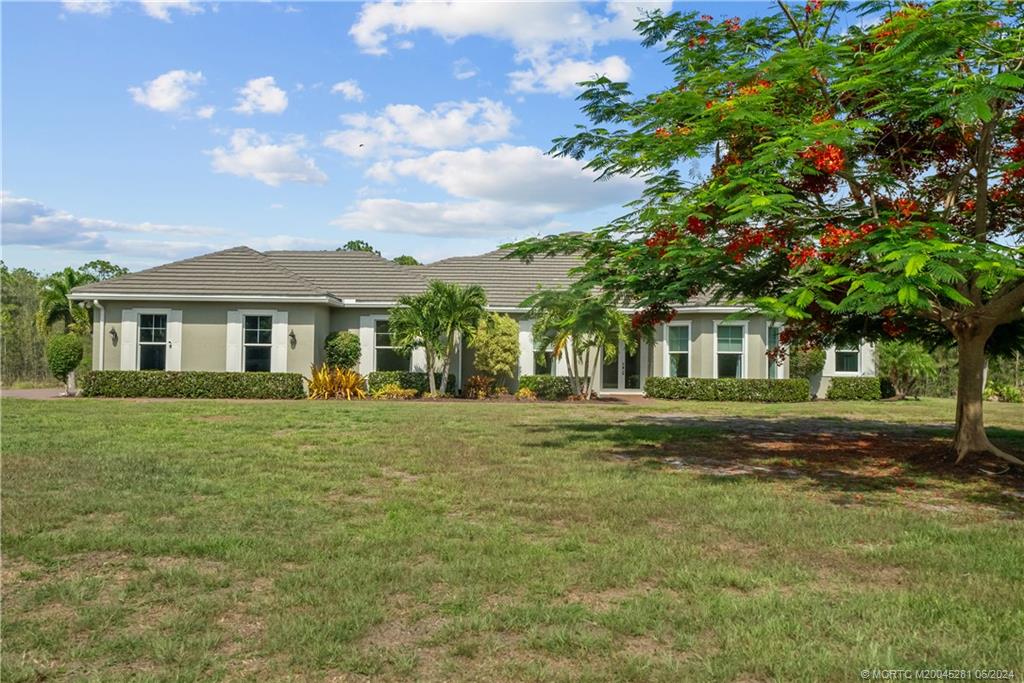 a front view of a house with a garden