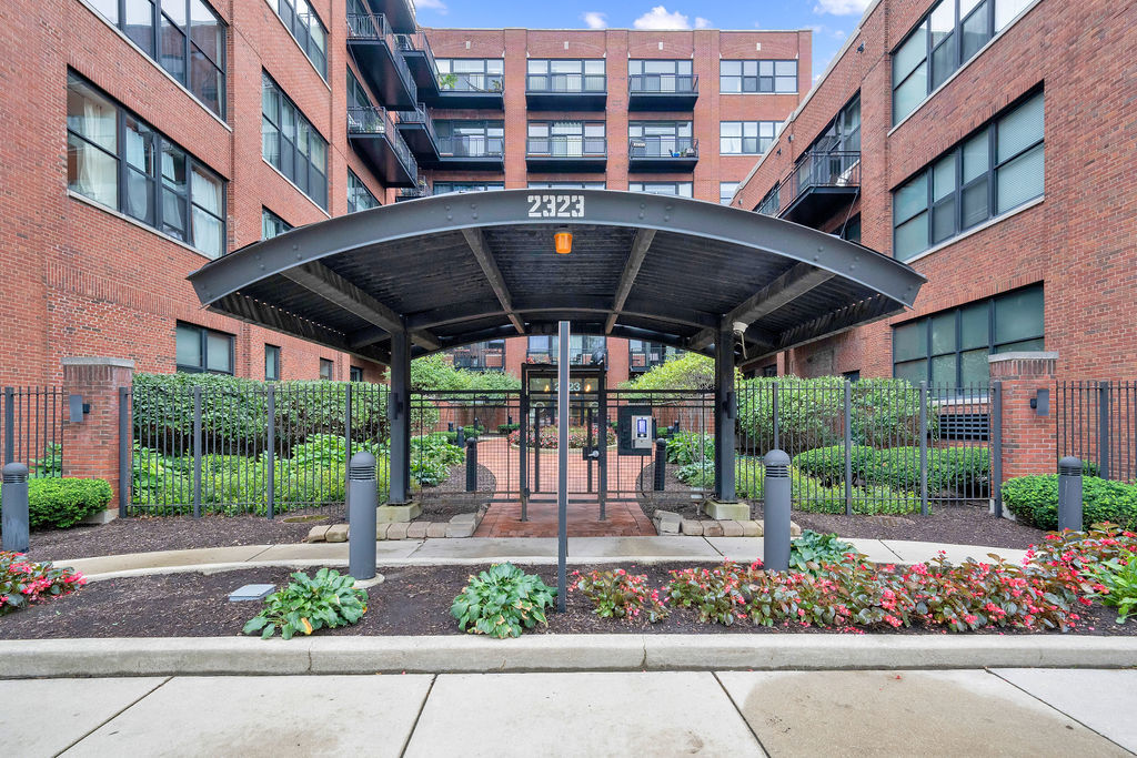 a front view of a building with a garden