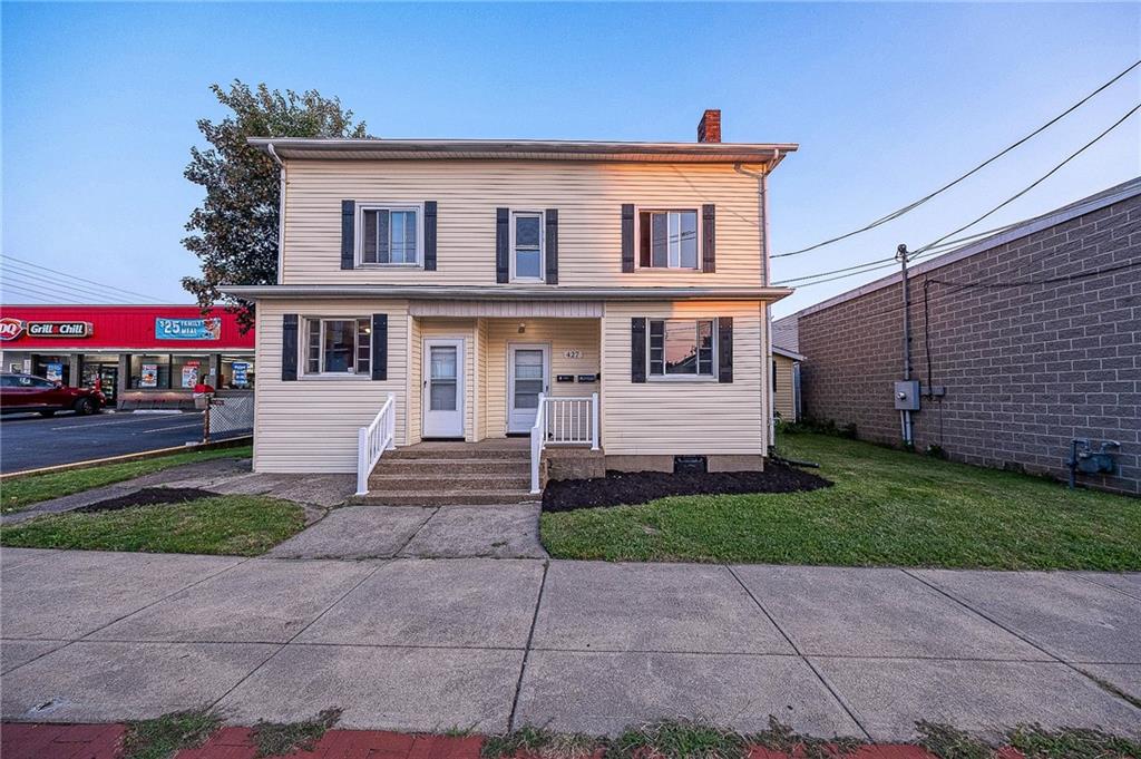 a front view of a house with a yard