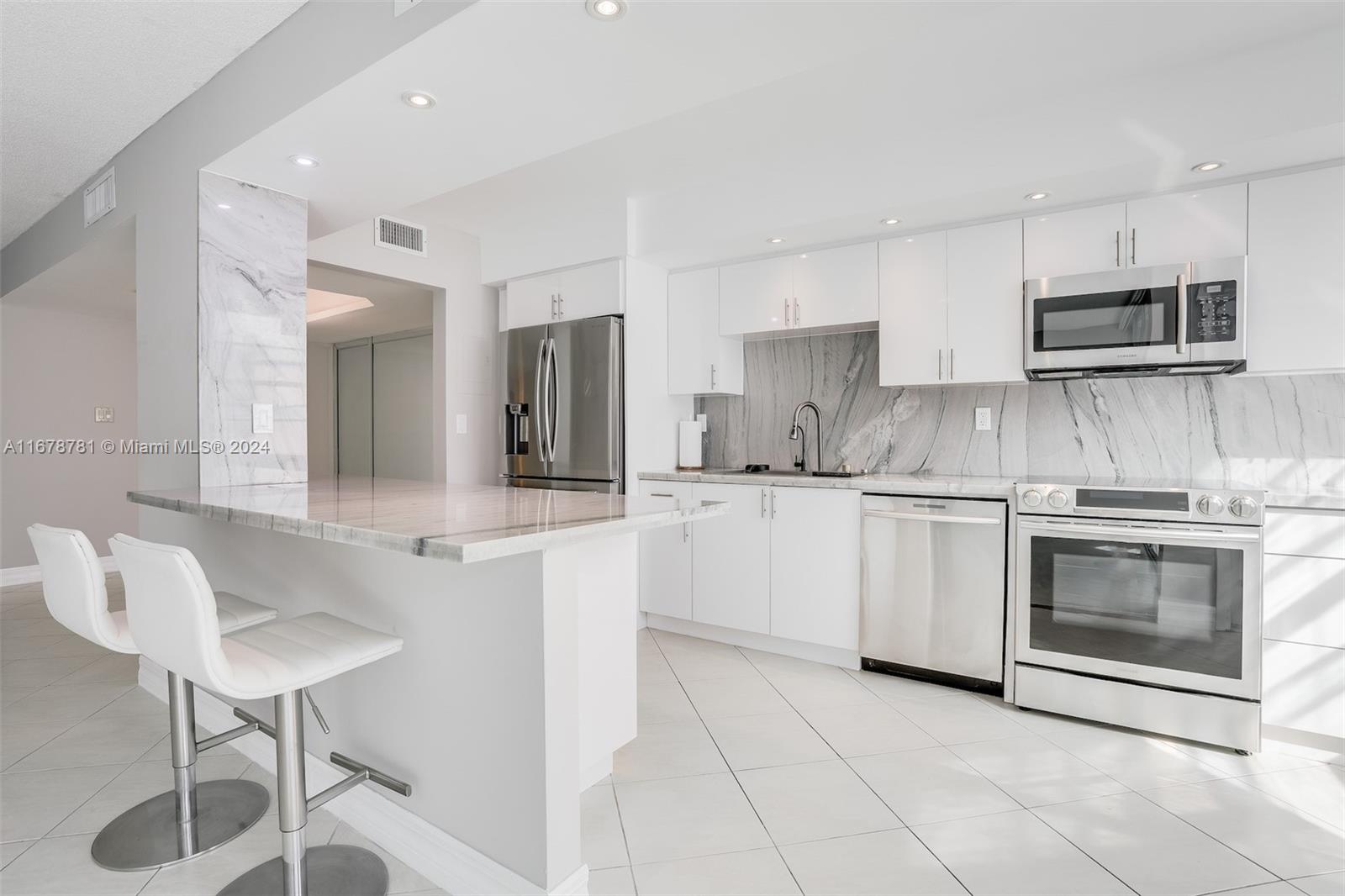 a kitchen with cabinets and chairs