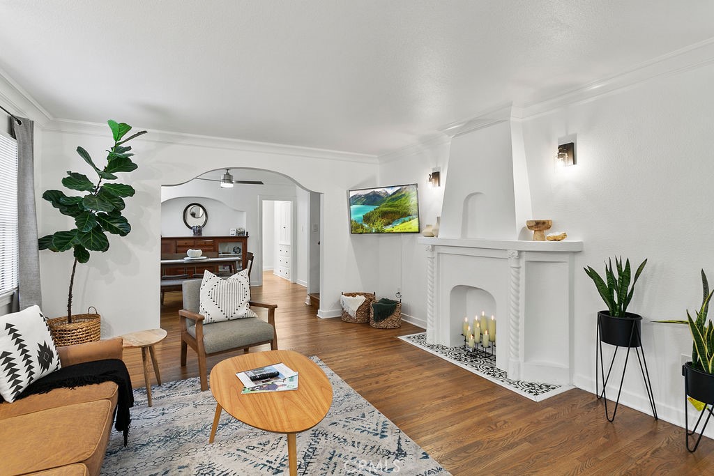 a living room with furniture a fireplace and a potted plant