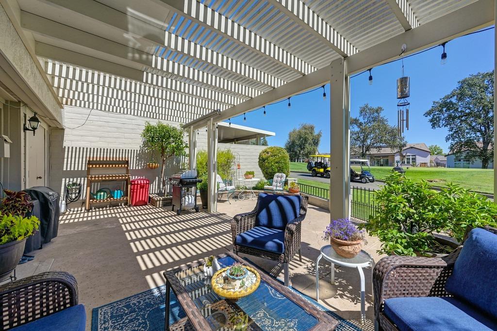 a view of a patio with couches table and chairs and potted plants