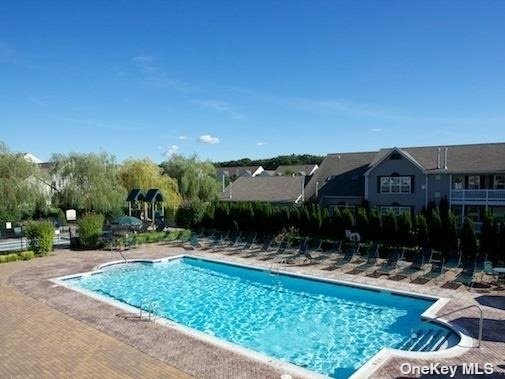 a front view of a house with swimming pool and patio