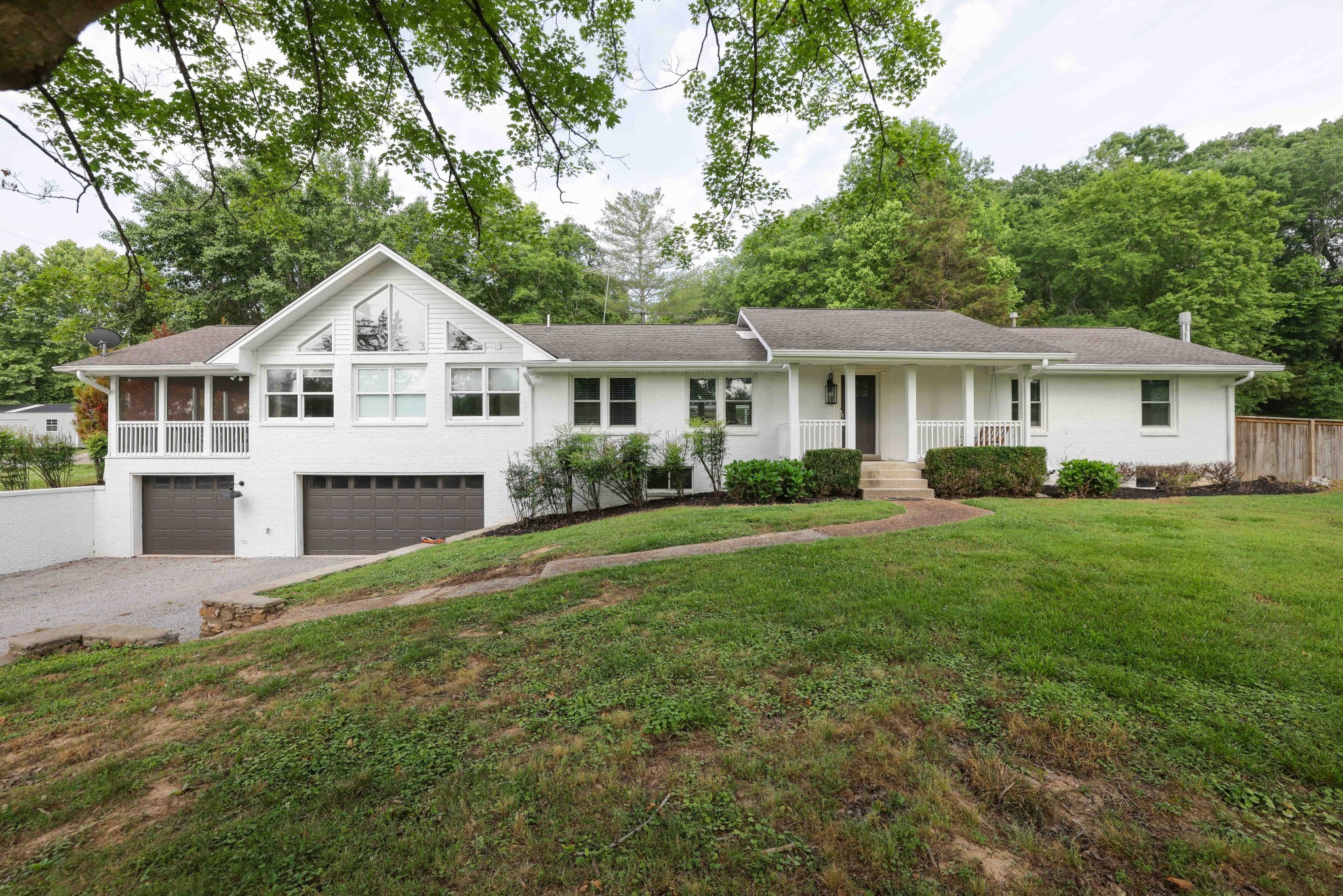 a front view of a house with a garden