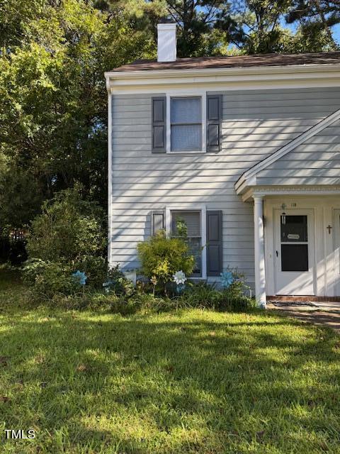 a view of a house with a yard and plants