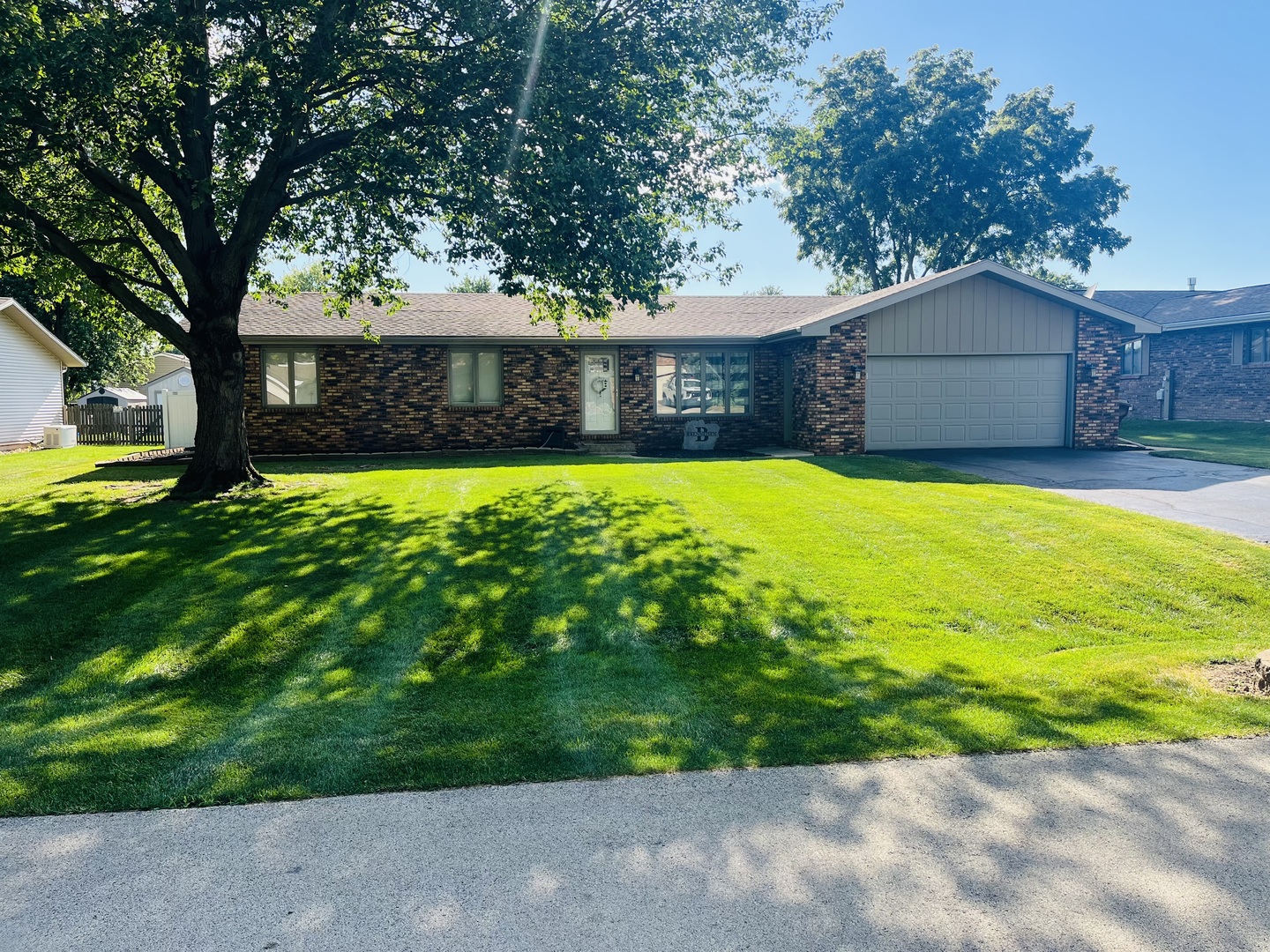 a front view of house with yard and trees