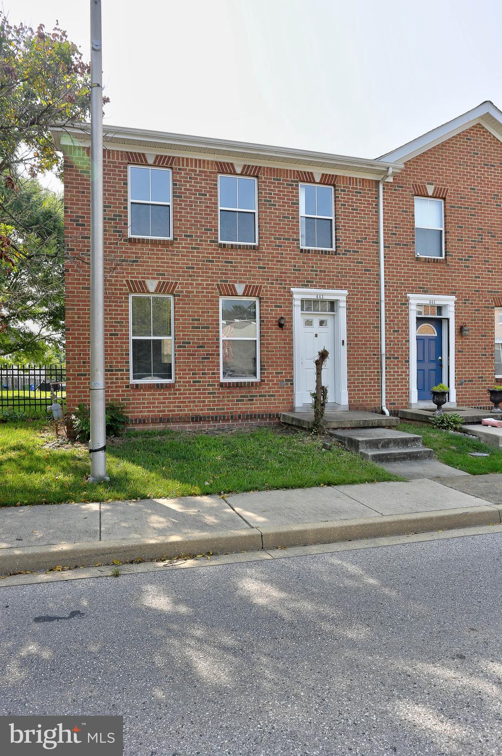 a front view of a house with a yard and a garage