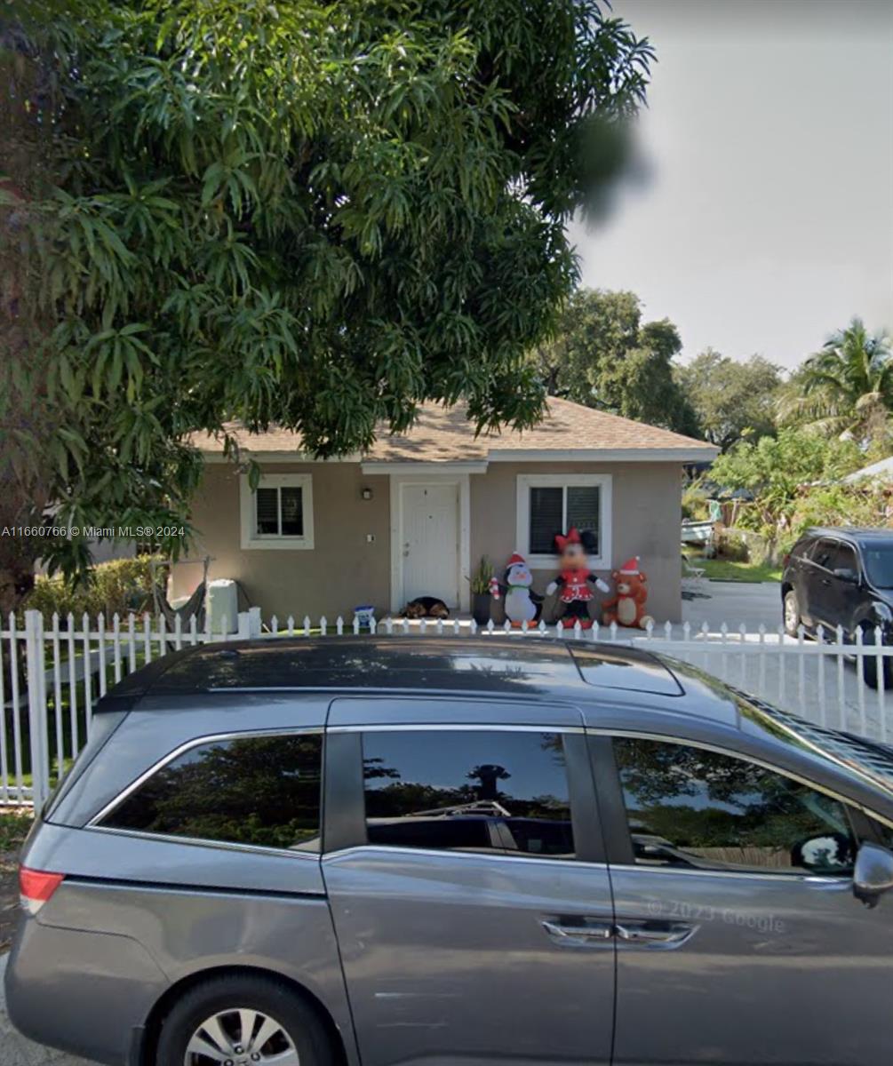 a view of a house with car parked