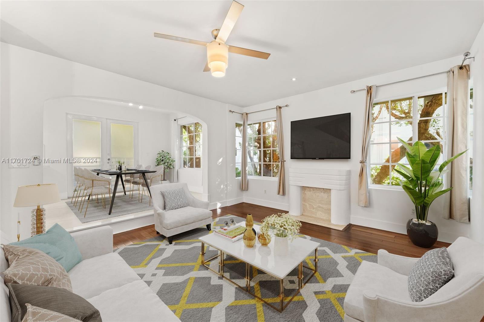 a living room with furniture a fireplace and a flat screen tv