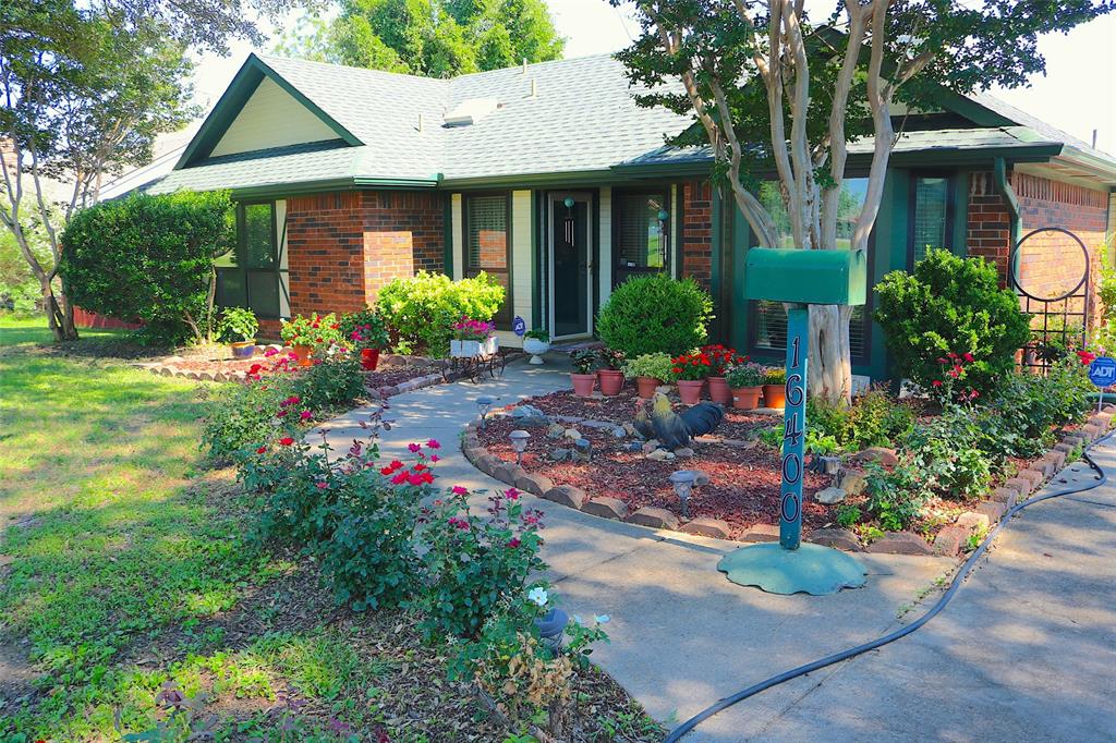 a view of a house with a yard and garden