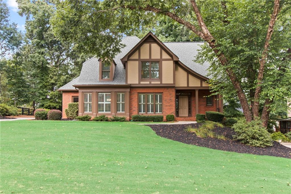 a front view of a house with a garden