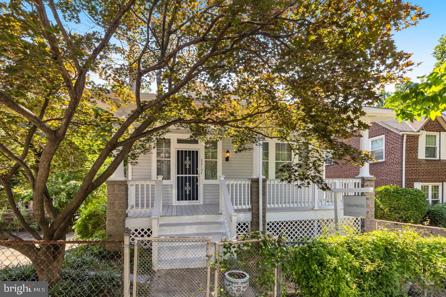 front view of a house with a tree