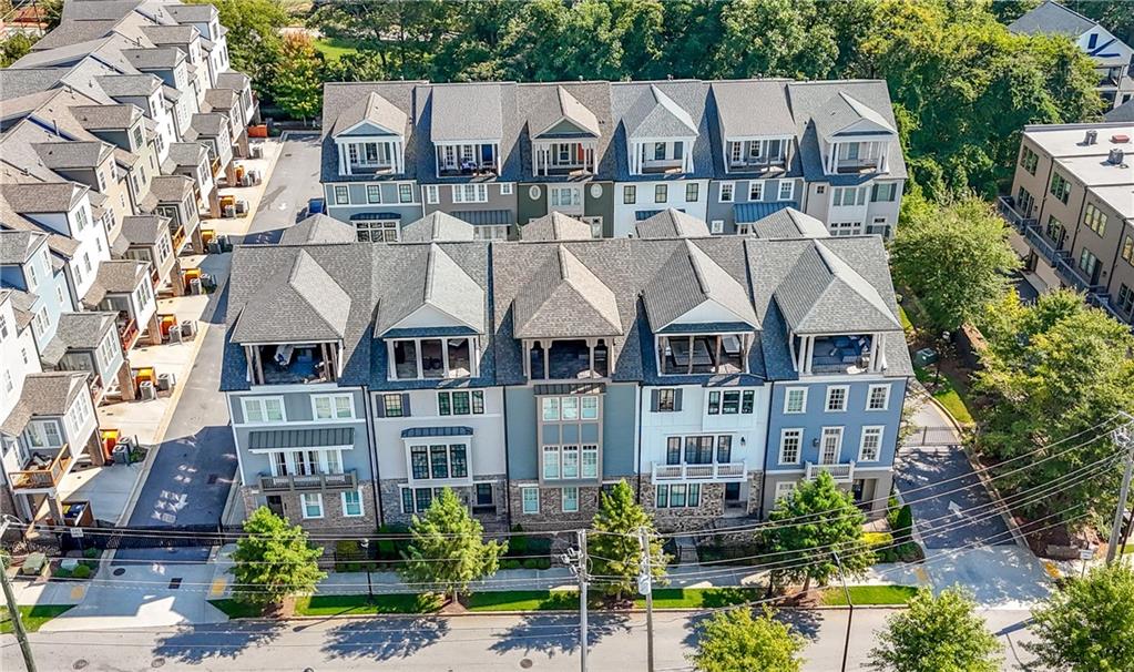 a aerial view of a brick building next to a yard