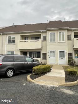 a front view of a house with a parking space