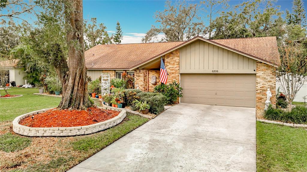 a view of a house with backyard and trees