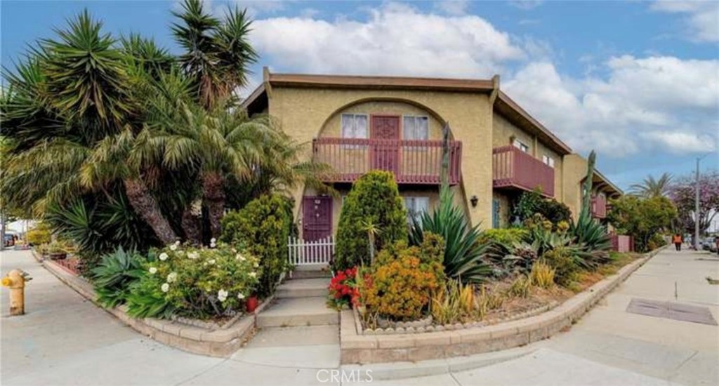 a view of a brick house with potted plants