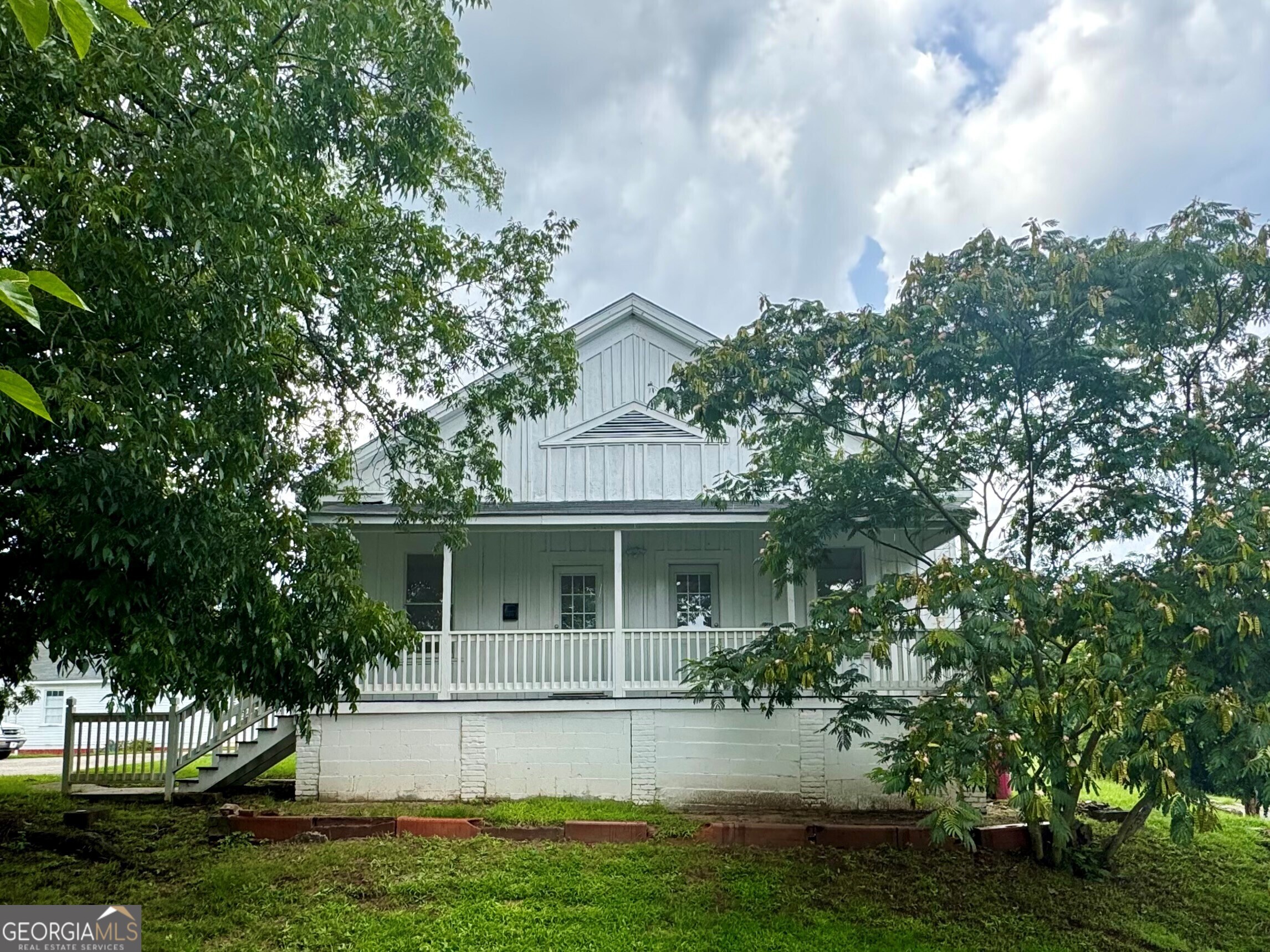 a front view of a house with yard and green space