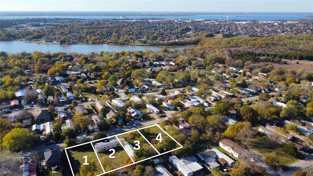 an aerial view of residential building with parking and yard