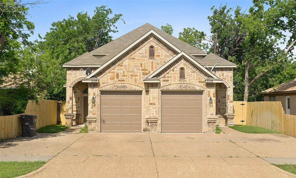 a view of a house with a yard and garage