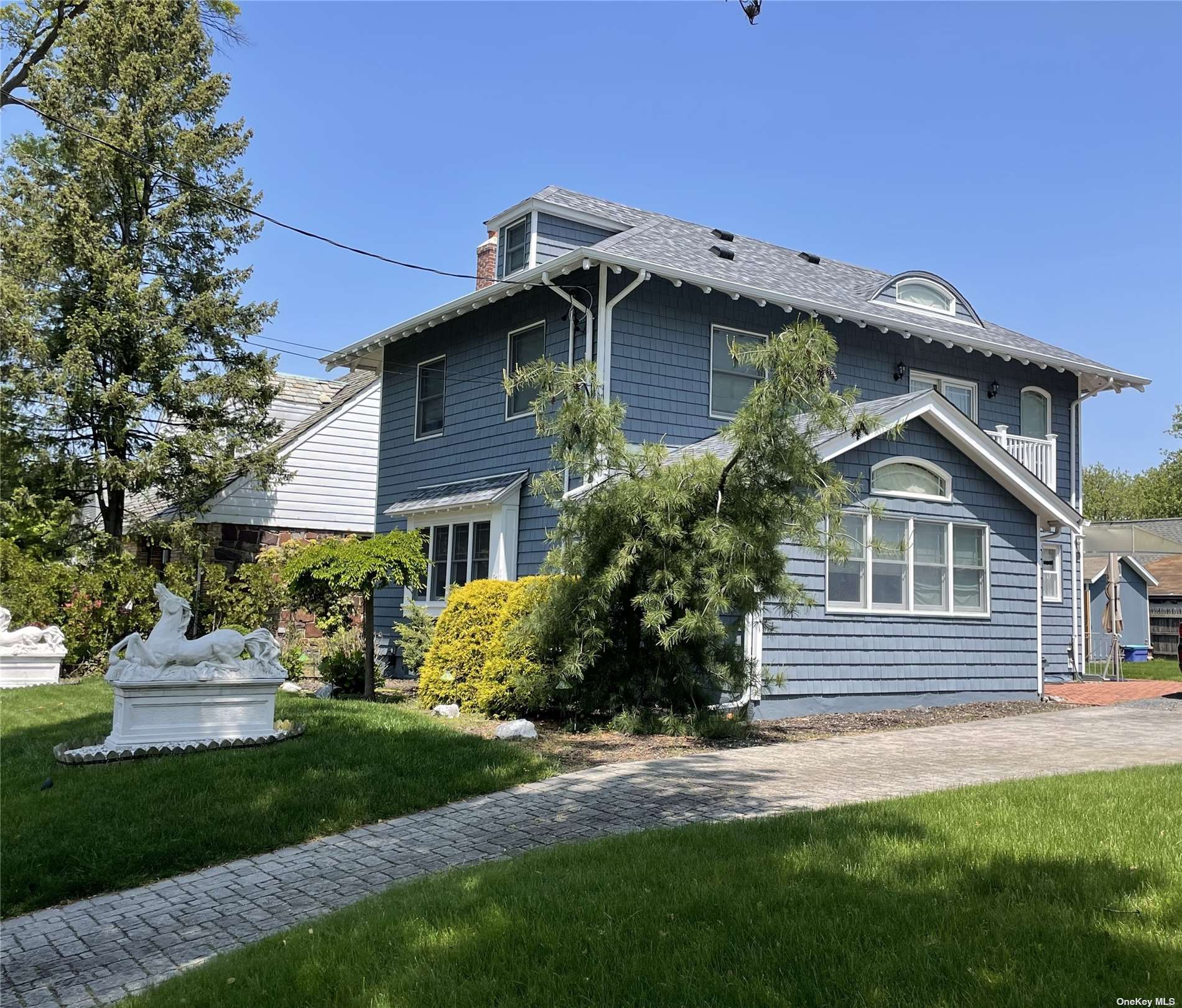 a front view of a house with a garden