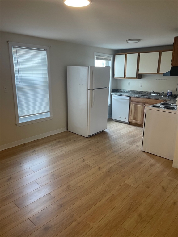 a kitchen with granite countertop a stove and cabinets