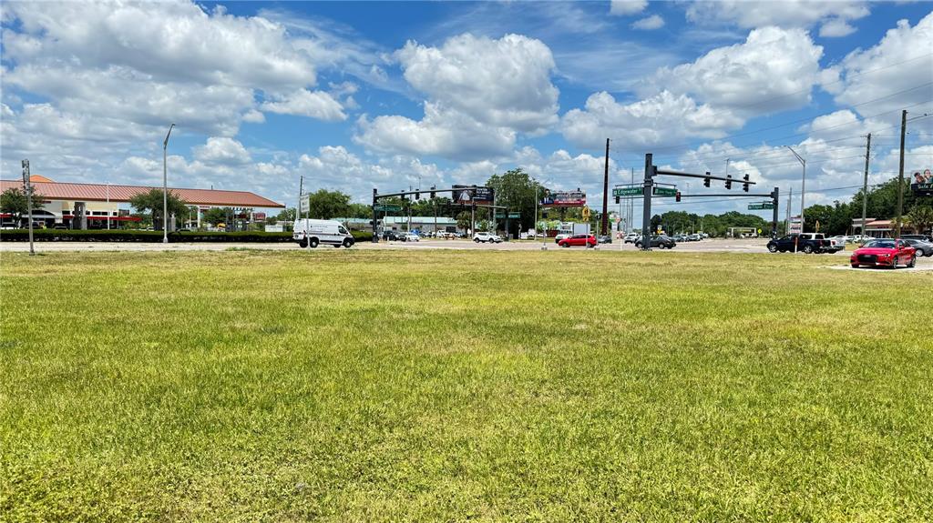 a view of a big yard with a building in the background