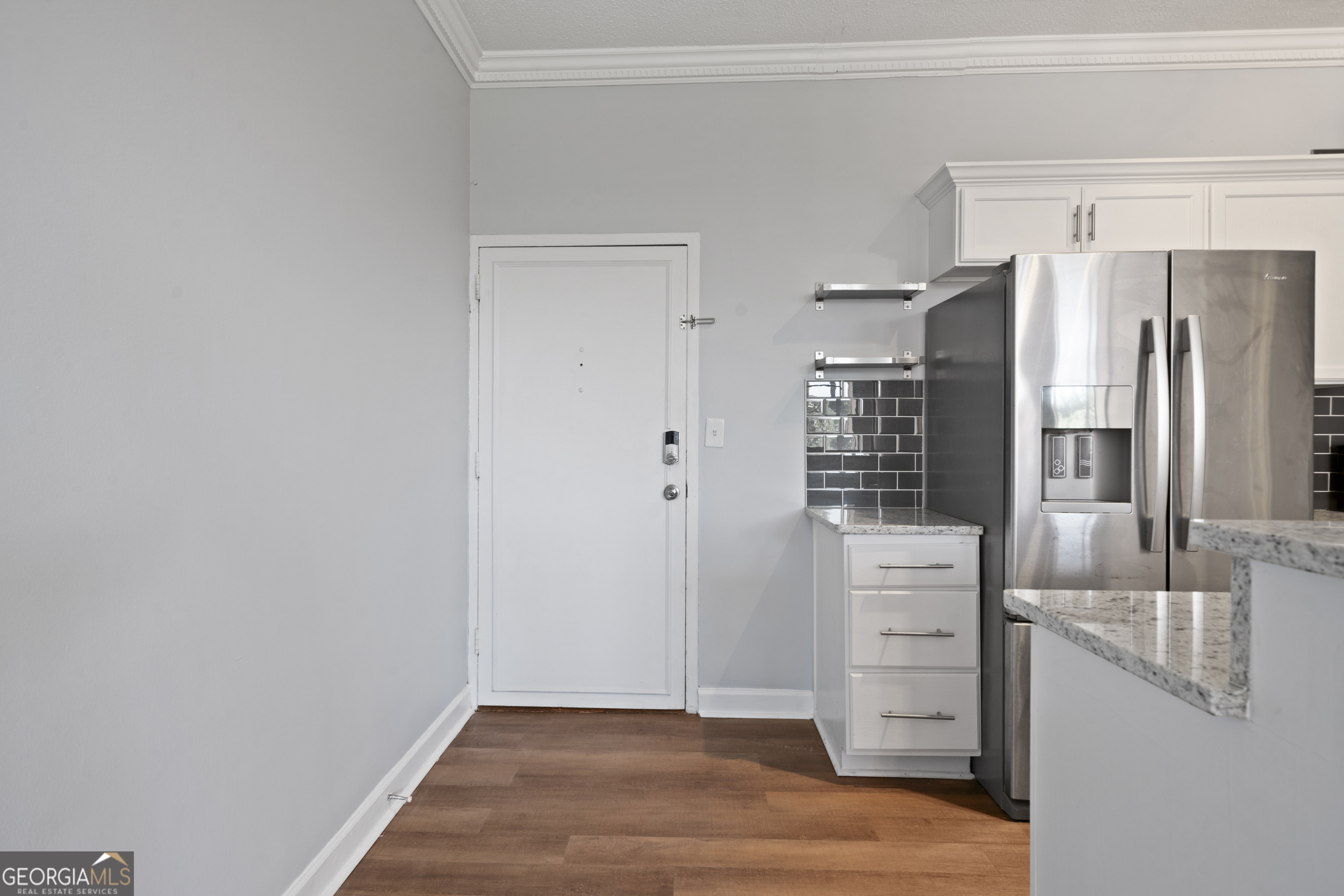 a view of kitchen with refrigerator cabinets and outdoor view