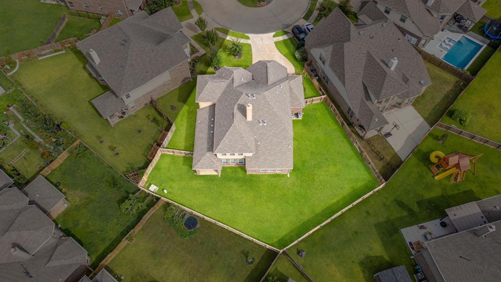 an aerial view of a residential houses with outdoor space