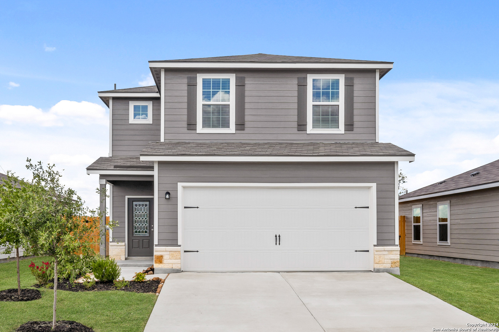 a front view of a house with garden