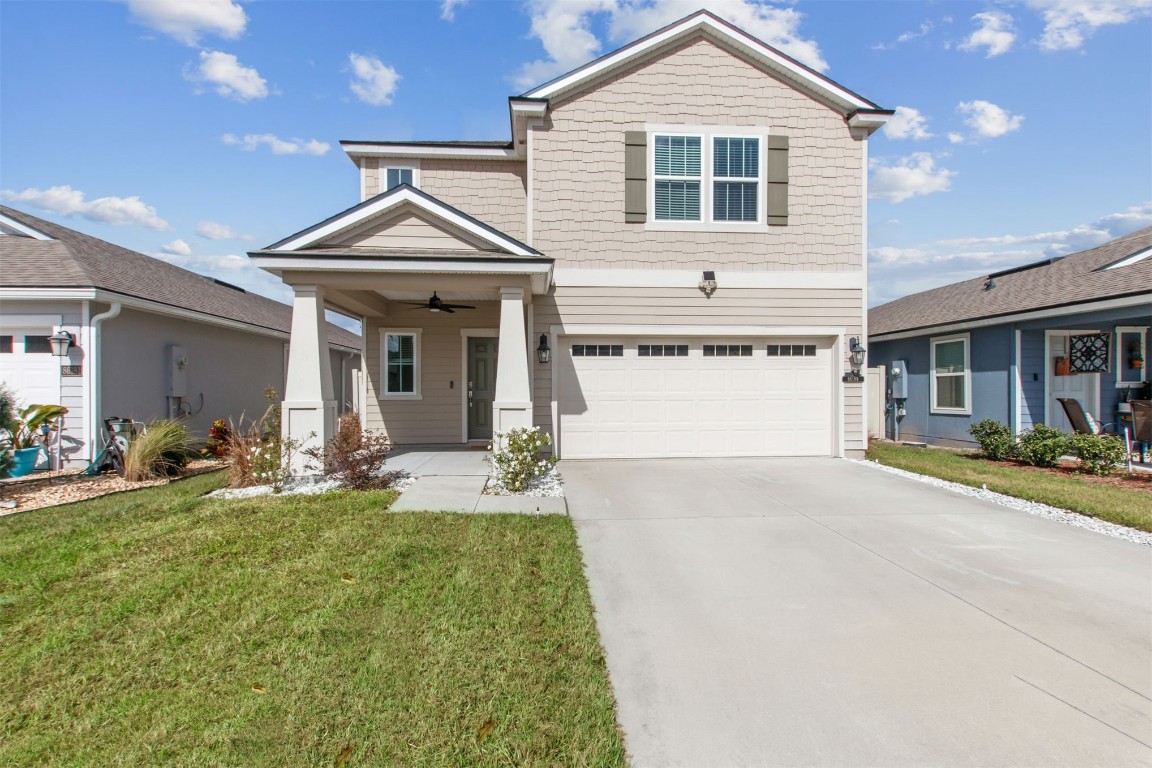 a front view of a house with a yard and garage