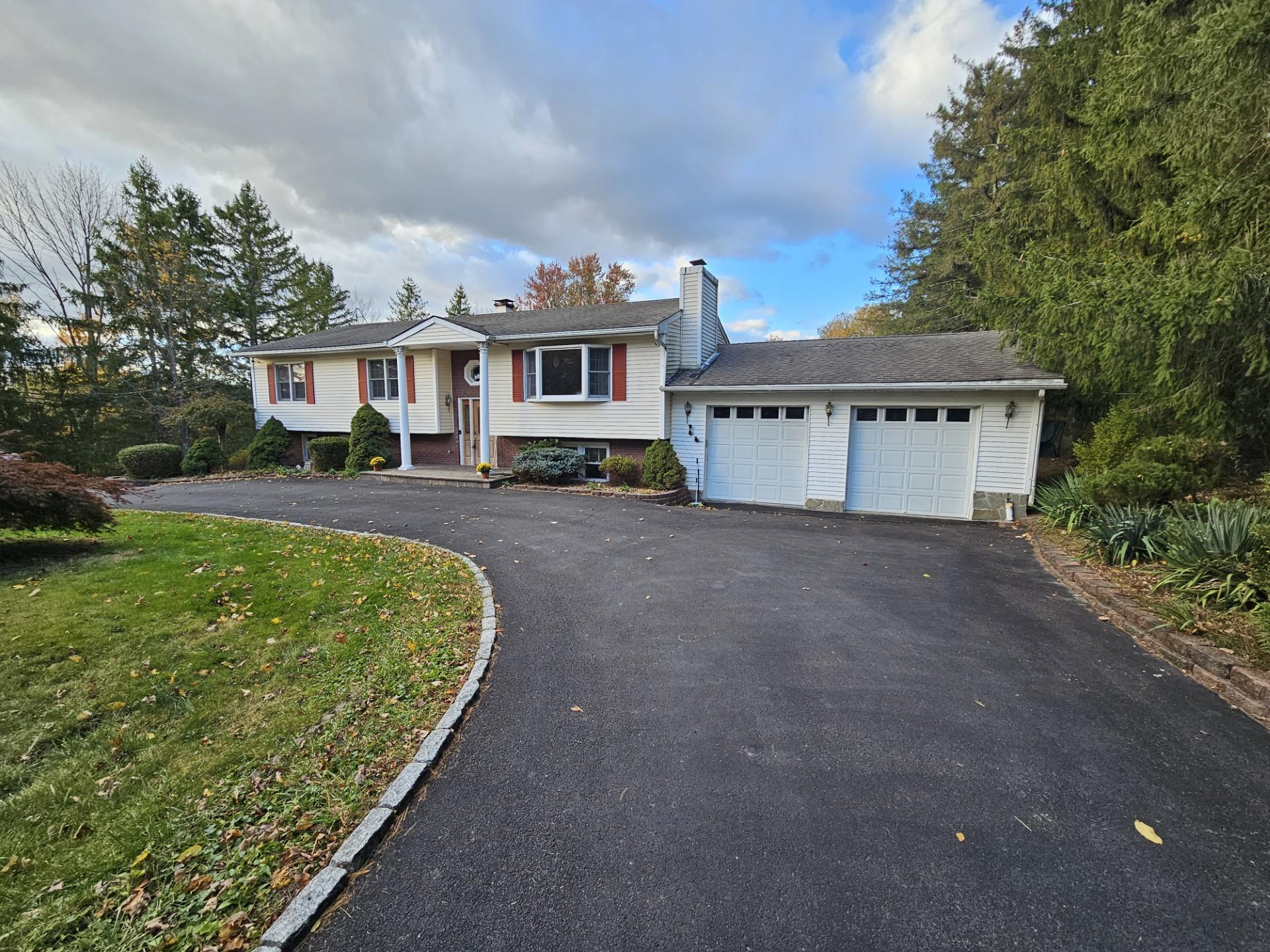 View of front of house with a garage and a front yard