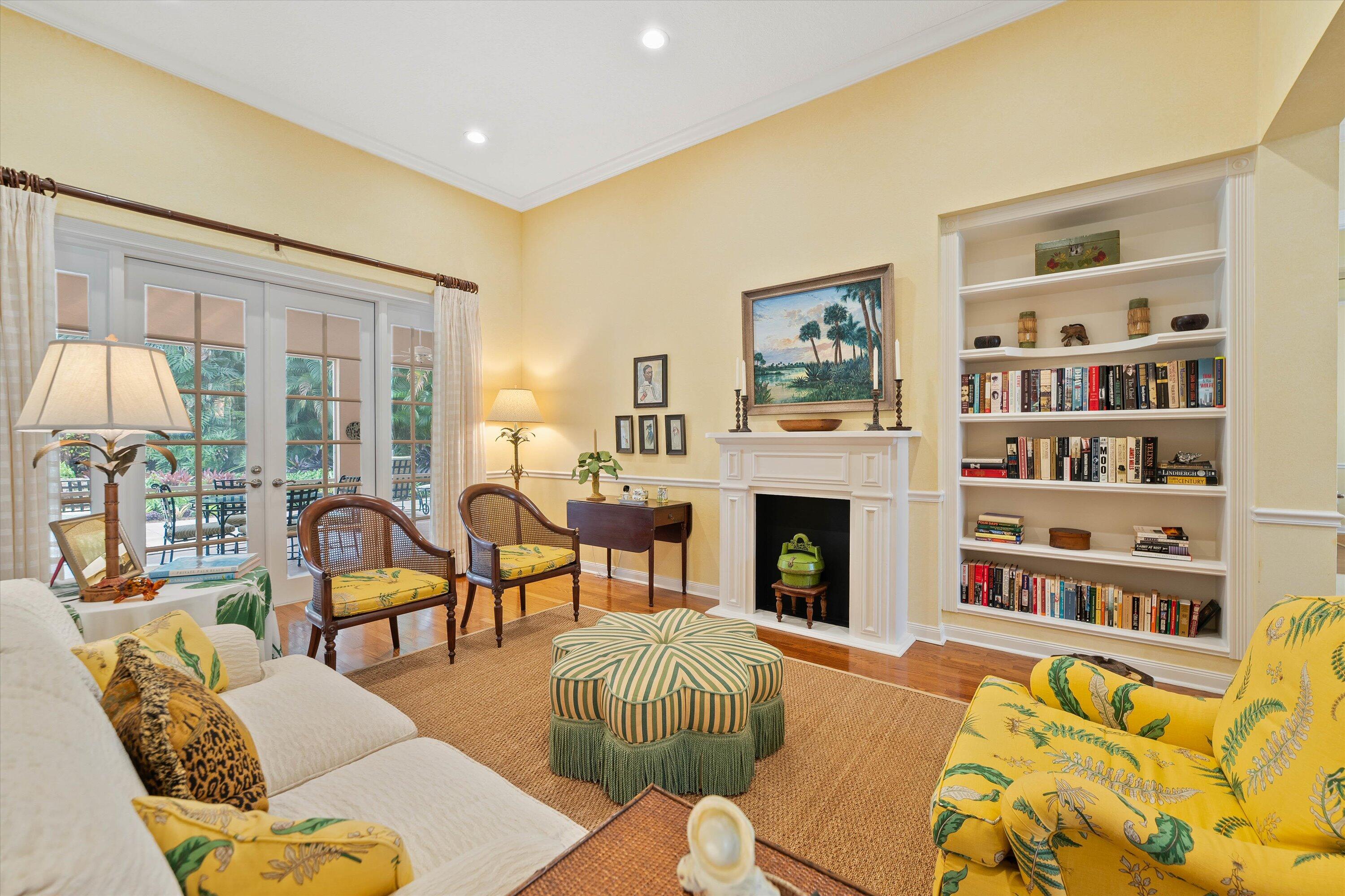 a living room with fireplace furniture and a large window