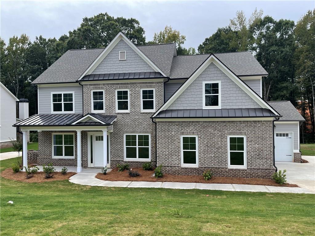 a front view of a house with a yard porch and outdoor seating