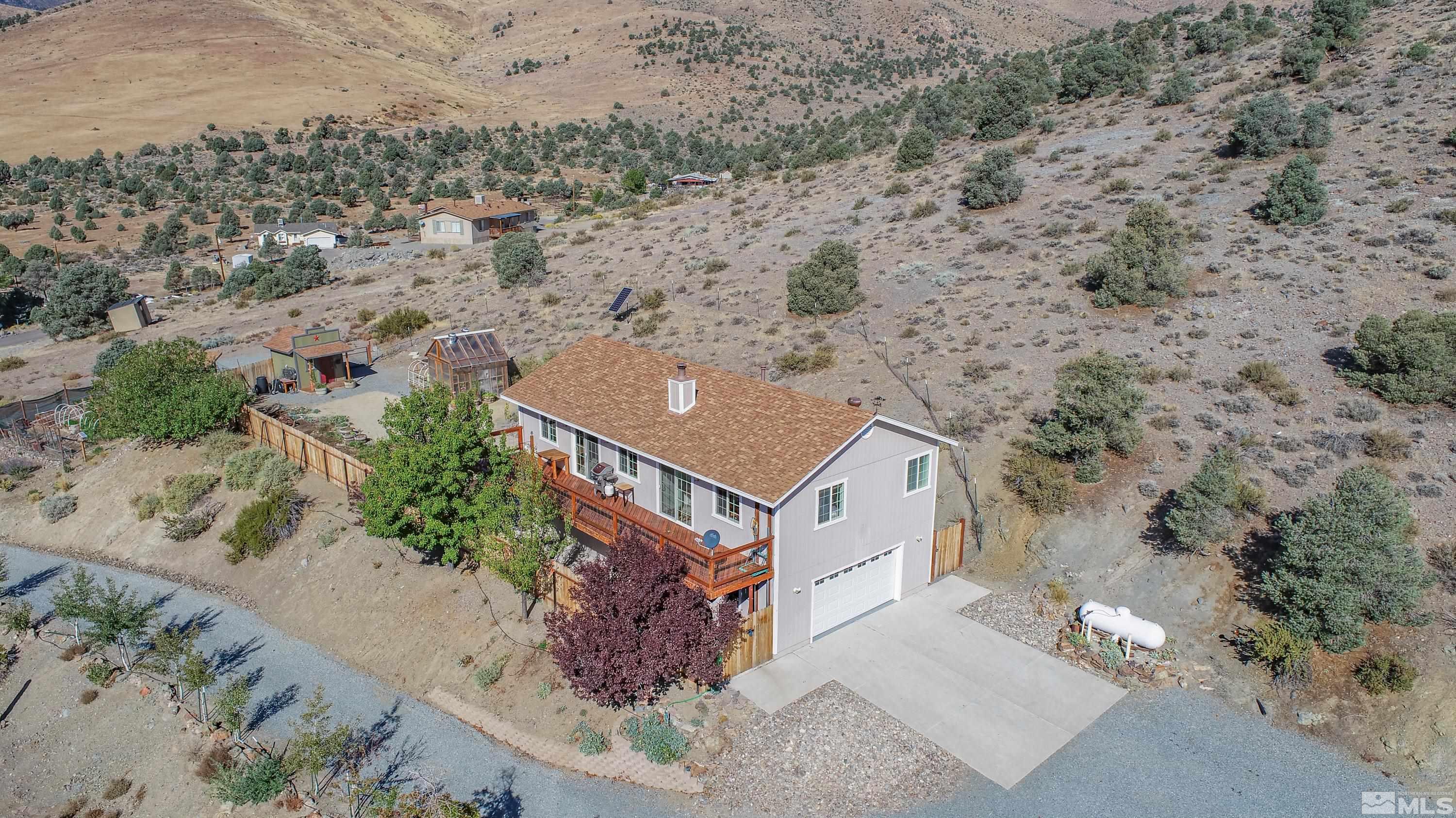 an aerial view of a house with a yard