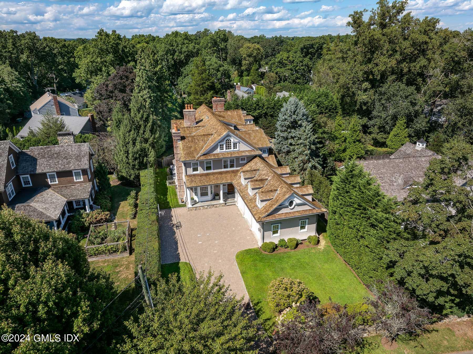 an aerial view of a house with a yard basket ball court and outdoor seating