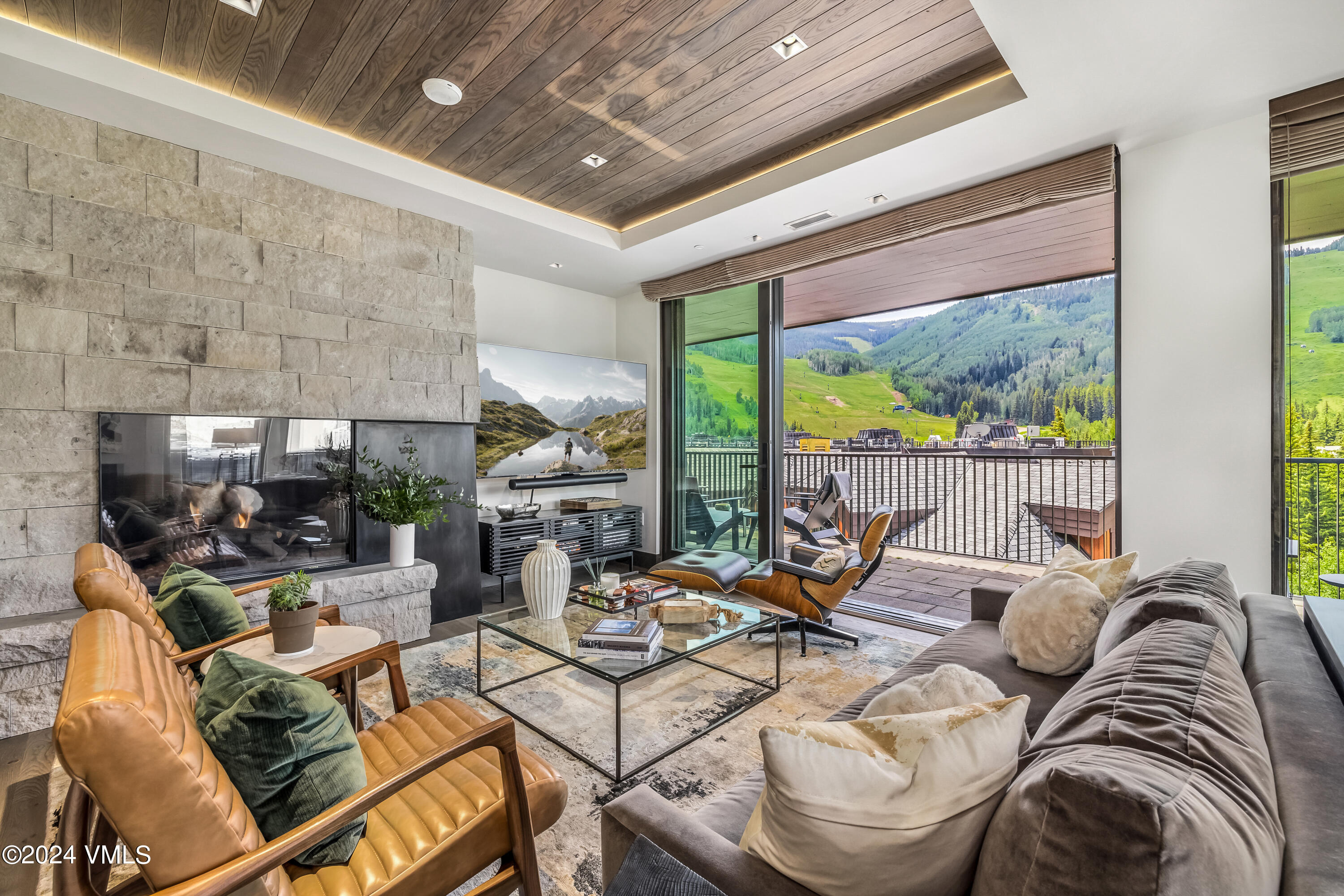 a living room with furniture and outdoor view