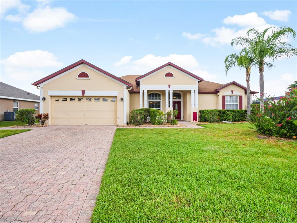 a front view of a house with a yard and garage