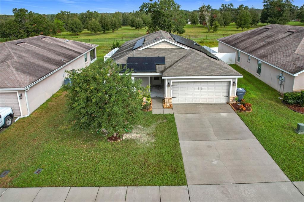 a aerial view of a house with a yard